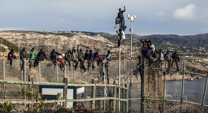 Refugees injured as 500 storm over 20-foot fence from Morocco into Spanish city in North Africa